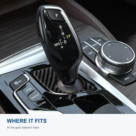 Carbon fiber trim installed around the gear selector base in a left-hand-drive BMW G30.