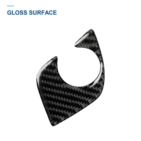 Angled view of the glossy woven carbon fiber surface and shaped edge of the BMW G30 shifter base trim.