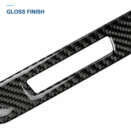 Close-up of the glossy carbon fiber weave and opening edge on the seat memory button trim.